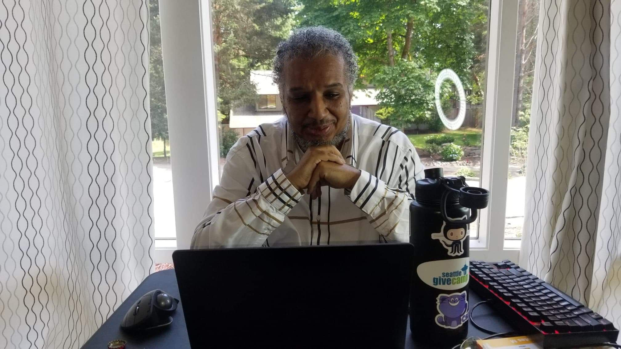 Michael Brown participating in the Juneteenth Conference from home on his computer