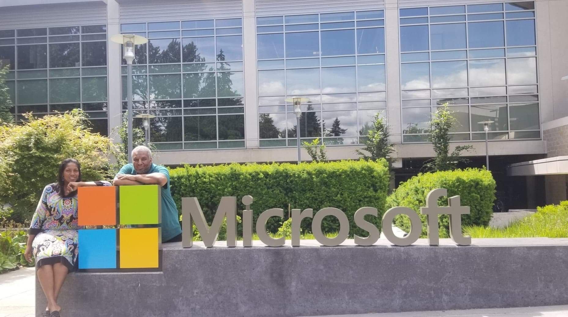 Michael Brown and his wife take the requisite 'first day' photo by the Microsoft logo